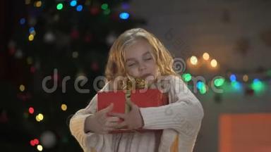 女孩拥抱扭曲的礼盒，期待已久的圣诞礼物，梦想成真